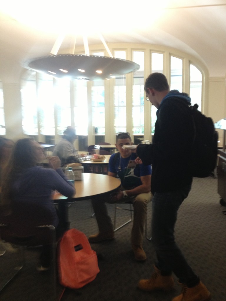 Albany students pass out pocket Constitutions to students in the dining hall