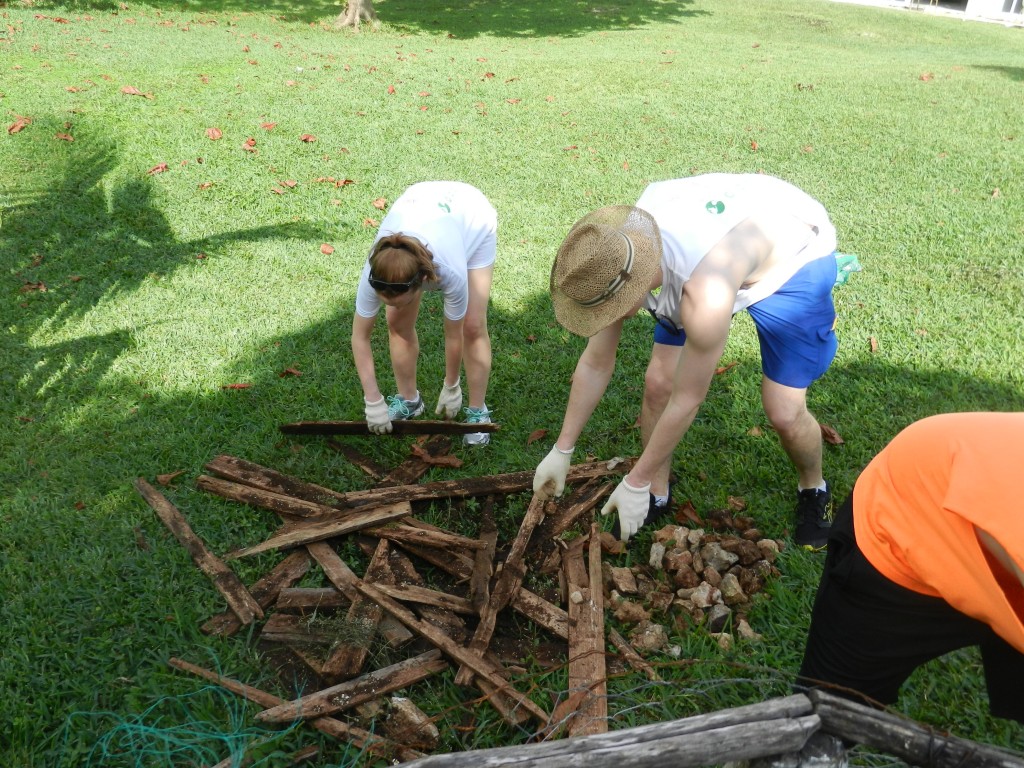 Students in the "garden box" group work on clearing old, deteriorated wood to prepare for the supplies on the way.