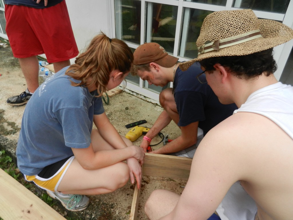 The "garden box" crew works hard to build sturdy boxes that will serve as home to a new variety of vegetables for the residents.