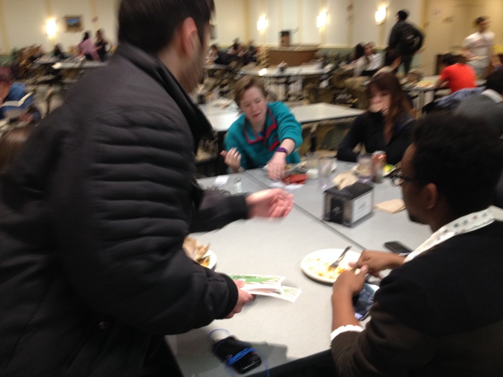 Julian Hassan distributes REAL Energy literature to students in the Vassar dining hall.